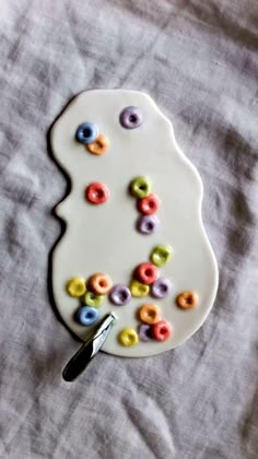 a white plate topped with lots of colorful donuts