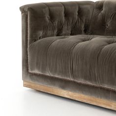 a brown couch sitting on top of a white floor next to a wooden frame and headboard