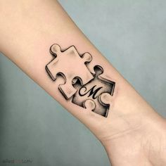 a person's arm with a piece of puzzle on it and the word me written in black ink