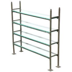 a metal shelf with glass shelves on it