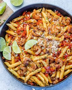 a skillet filled with pasta, meat and sauce