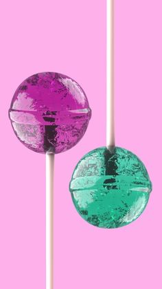 two lollipops on a pink and green background