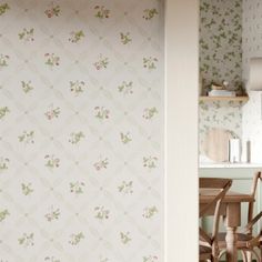 the wall paper in this kitchen is very pretty