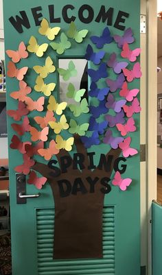 a classroom door decorated with paper butterflies and the words spring days written in black on it