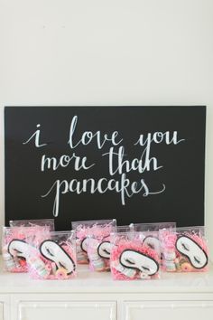 there is a sign that says i love you more than pancakes on it