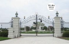 an iron gate is in front of a white house