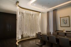 an elegant dining room with white curtains and chairs