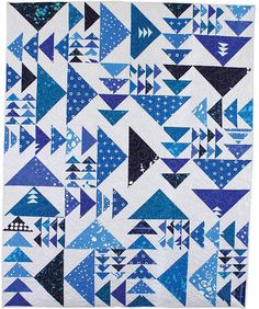 a blue and white quilt with many triangles on it's sides, all in different sizes