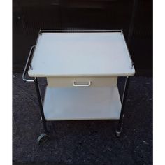 a white cart with two drawers on wheels