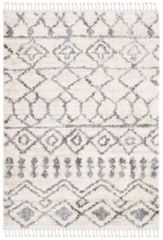 a white and gray rug with fringes on the bottom, in front of a white background