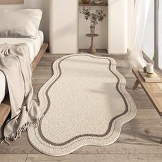 a large white rug in the middle of a room with a bed and window behind it