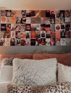 a bed with some pillows and pictures on the wall