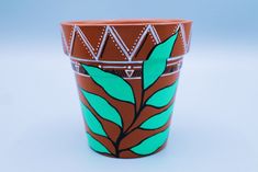 a brown and green cup sitting on top of a table