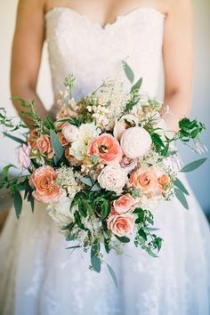 a bride holding a bouquet of flowers in her hands