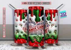 three red and green cans with candy canes on them in front of a white wall