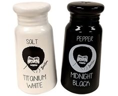 two salt and pepper shakers with the same image on them, one black and one white