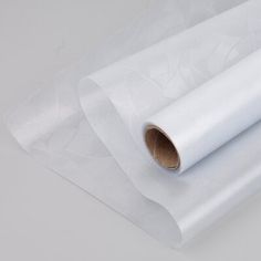 a roll of white paper sitting on top of a table