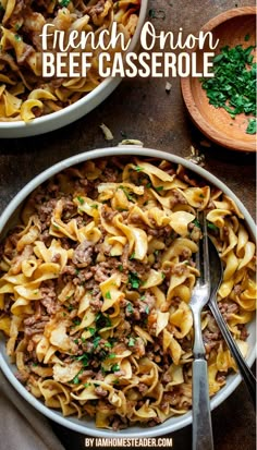 A beige bowl is filled with French onion beef casserole and has a silver spoon and fork in it. Around the bowl is a small wooden bowl of parsley, and another identical bowl of French onion beef casserole, all on a dark countertop. French Onion Beef And Noodles Casserole, What To Make With French Onion Soup, French Onion Beef Noodle Bake 12 Tomatoes, French Onion And Beef Noodles, Creamy French Onion Beef And Noodles, Ground Beef And French Onion Soup, French Onion Soup Hamburger Recipes, French Onion Noodle Casserole, Ground Beef And Onion Soup Mix Recipes