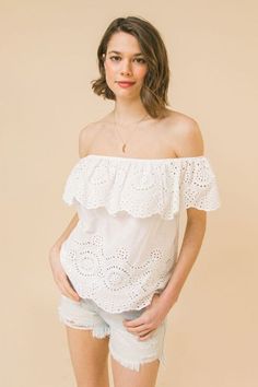 This White Eyelet Off Shoulder Top is the ultimate summer blouse that goes with just about anything! Pair this white eyelet blouse with Bella Chic Fashion jeans, shorts, or skirts. Product Description: A woven eyelet top featuring off the shoulder neckline with flounce, and relaxed body Details Self :100% Exclusive of decoration Size & Fit - Model is 5'8" And Wearing Size Small - Measurements Taken From Size Small - Approx. Length: 16.5" Summer Off-shoulder Top With Ruffles And Short Sleeves, Summer Off-shoulder Ruffled Top With Short Sleeves, Summer Off-shoulder Ruffled Tops, Off-shoulder Ruffled Tops For Summer, Off-shoulder Ruffled Summer Tops, Feminine Summer Eyelet Blouse, Spring Cotton Off-shoulder Top With Ruffles, Spring Ruffled Off-shoulder Top With Short Sleeves, Summer Off-shoulder Top With Ruffles For Vacation