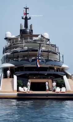 people are standing on the deck of a large boat