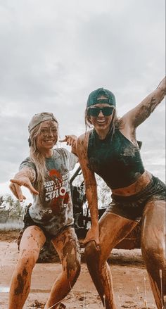 two women are playing in the mud together