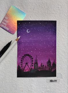 a card with a painting of a ferris wheel and the moon in the night sky