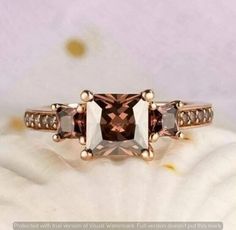 an engagement ring with two brown and white diamonds