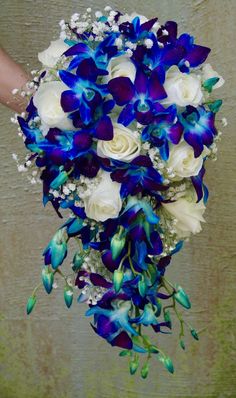 a bridal bouquet with blue and white flowers