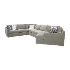 a large sectional couch with pillows on the top and bottom corner, in grey fabric