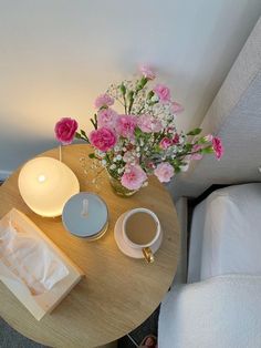 a table with flowers and a candle on it