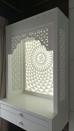 a white cabinet with an intricate cut out window