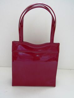 "Even Barbie would have loved carrying this classy handbag to one of her many fashion events! This fabulous purse is made of high gloss ruby red patent leather. The purse has two handles, a softly scalloped top with a V-hinged opening. The inside is completely lined in black fabric with an internal pocket measuring 5 wide by 2 3/4\" deep. The purse measures 8\" wide by 8 1/2\" tall with a 4\" gusset, straps 14\" long. Large enough to hold a cell phone, keys, small coin purse, lipstick, etc. Purs Fashion Events, Small Coin Purse, Patent Leather Handbags, Polka Dot Scarf, Vintage Clothes Women, Vintage Purses, Small Handbags, 1950s Vintage, Vintage Handbags