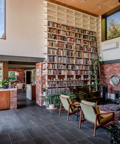 a living room filled with lots of furniture and bookshelves next to a fire place