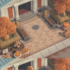 an aerial view of a house with pumpkins on the ground