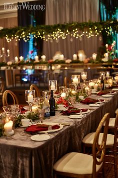 a long table is set with place settings and candles for an elegant christmas dinner party