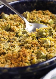 a casserole dish with broccoli and rice in it, ready to be eaten