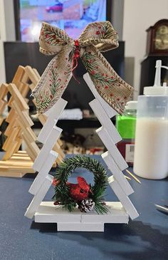 a wooden christmas tree with a wreath on top