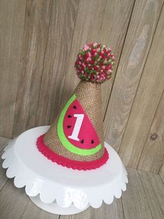 "Please read shop announcement for current processing times and updates. Your birthday girl is ONE in a Melon! Celebrate with this adorable birthday hat and banner, perfect for a party or photo shoot. This hat is available in 2 sizes, Mini which is about 5 inches tall and 4 inches wide or Full size which is 7 inches tall by 5 inches wide. It features a burlap base with a watermelon and white glitter number 1 topped with a hot pink, pink and lime pom pom and embellished with hot pink mini pom pom 1st Birthday Party Hat, First Birthday Hat, Baseball Theme Birthday, Glitter Number, First Birthday Hats, Mini Pom, Cake Banner Topper, Baseball Birthday, Birthday Party Hats