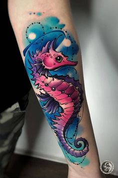 a colorful seahorse tattoo on the arm