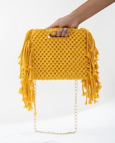 "Introducing our gorgeous Macrame Fringe Bag - an eccentric and quirky accessory that is perfect for any occasion! This bag is incredibly versatile, making it a perfect choice for any outfit. You can carry it as a sling bag or grab the handle for a clutch bag look. The fringes add quirk to the bag, making it a conversation starter.  Handmade with the utmost care and attention to detail, this stunning bag is sure to be a beloved addition to your wardrobe. It's easy to care for and can be dry cleaned. So what are you waiting for? Get one in your favorite color and get ready to slay the day!" Chic Macrame Bag For Everyday Use, Chic Everyday Macrame Bag, Handmade Yellow Clutch Bag, Chic Rectangular Macrame Bag, Chic Macrame Rectangular Shoulder Bag, Chic Rectangular Macrame Shoulder Bag, Party Bags With Braided Handles And Rectangular Shape, Rectangular Party Bags With Braided Handles, Rectangular Macrame Bags For Gifts