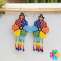 One of a kind earrings made with petite glass beads. Each design uses different shapes and colors, featuring a vibrant rainbow palette or just plain colors. Picture colors may slight different. Approximate length: 2.5 in Multicolor Beaded Flower Drop Earrings, Multicolor Beaded Drop Flower Earrings, Multicolor Flower-shaped Earrings With Colorful Beads, Nickel Free Multicolor Dangle Flower Earrings, Multicolor Nickel-free Dangle Flower Earrings, Nickel-free Multicolor Dangle Flower Earrings, Adjustable Multicolor Flower Earrings With Colorful Beads, Handmade Multicolor Teardrop Flower Earrings, Multicolor Round Beads Flower Earrings As Gift