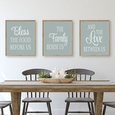 the dining room table is set up with two framed prints on the wall above it