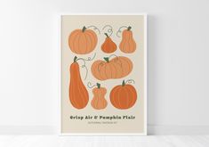 a poster with pumpkins and gourds on it in front of a white wall