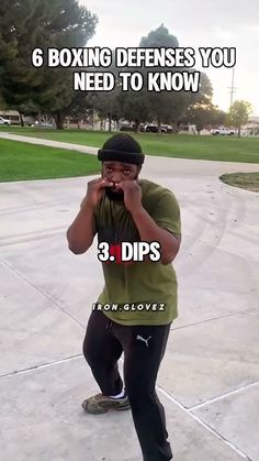 a man standing on top of a cement ground holding a cell phone to his ear