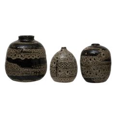 three black vases sitting next to each other