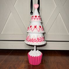 a cupcake shaped cake on top of a stand