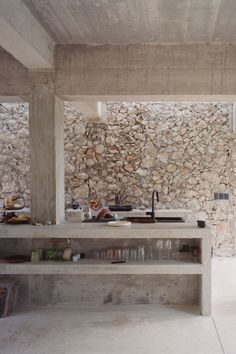 a kitchen with stone walls and counter tops