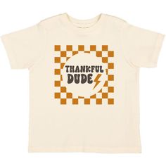 The Thankful Dude Checker Thanksgiving Short Sleeve T-Shirt is a fun and festive t-shirt for kids celebrating Thanksgiving! Features: Shirt Color: Natural Graphic Color: Mustard, Dark Gray Material: 100% Cotton Features: Tagless inside neck label for an itch-free wear Fit: Toddler Unisex; True to Size Care: Machine washable, tumble dry low, wash with like colors Each t-shirt is hand pressed with love using baby and child safe inks. Junior Girl Dresses, Thanksgiving Tee, Take Home Outfit, Thanksgiving Kids, Scarf Sale, Neck Label, Active Wear Shorts, Dresses Kids Girl, Girls Pajamas