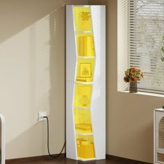 a tall white cabinet with yellow shelves in the corner next to a window and potted plant