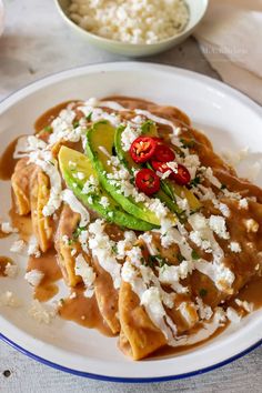 a white plate topped with food covered in gravy